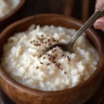 Close-up of creamy rice pudding served with cinnamon and raisins in a bowl